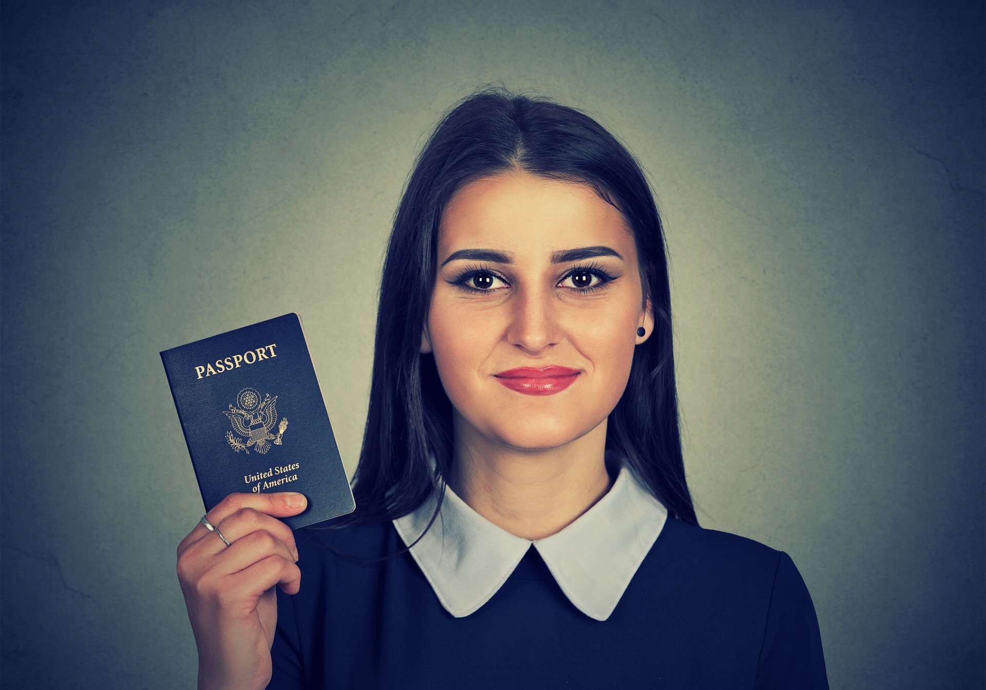 attractive young happy woman with USA passport