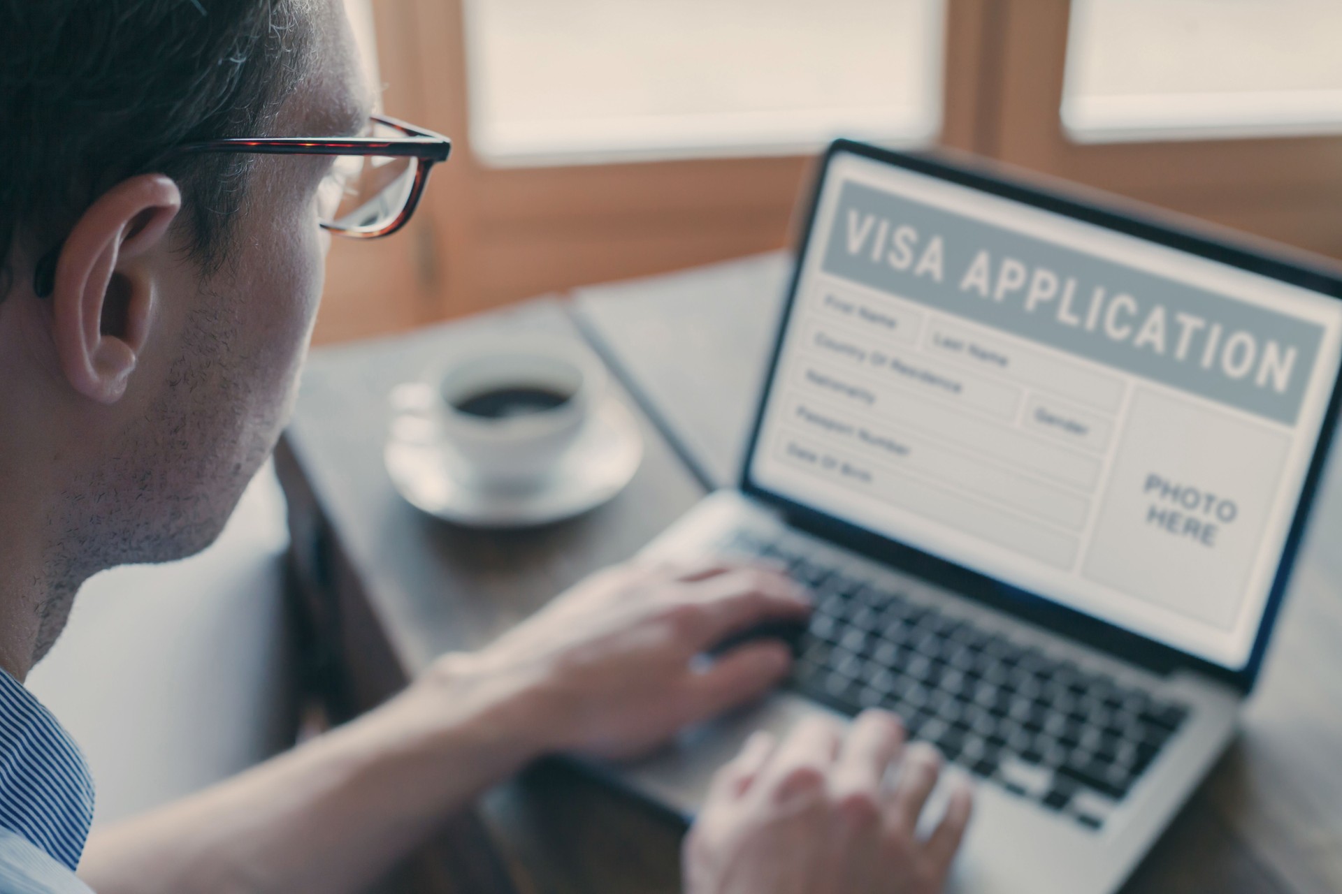 Online visa application, man filling form for immigration or tourism visa